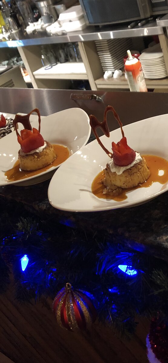 Close-up of a decadent dessert cake topped with fruit and sauce