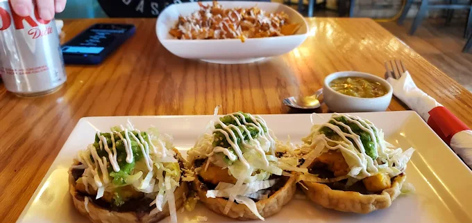 Sopes with beans, lettuce, and cheese