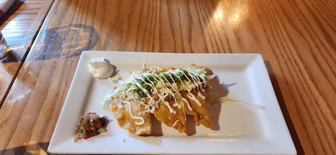 Empanadas served with fresh garnish and dipping sauce